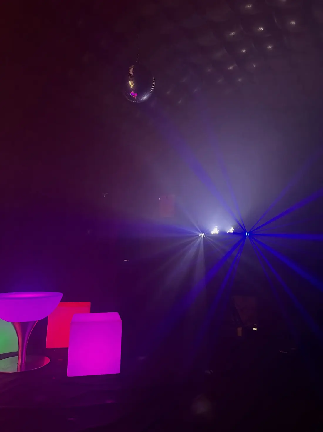 Inside the nightclub: lasers, smoke and a disco ball over LED furniture
