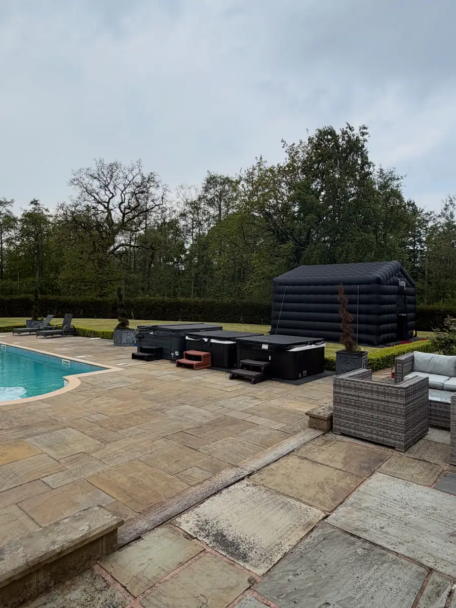 The nightclub set up on a lawn beside a swimming pool and patio